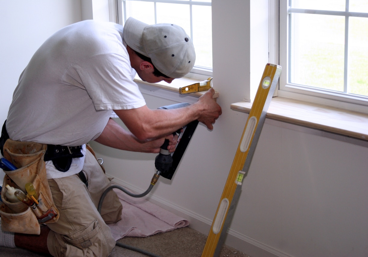 Employee diligently working in summer time on window