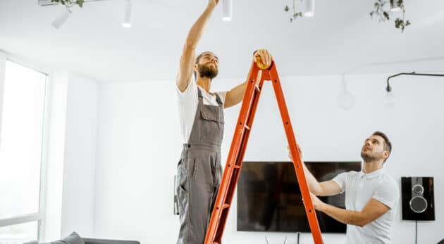 Men installing lights at home