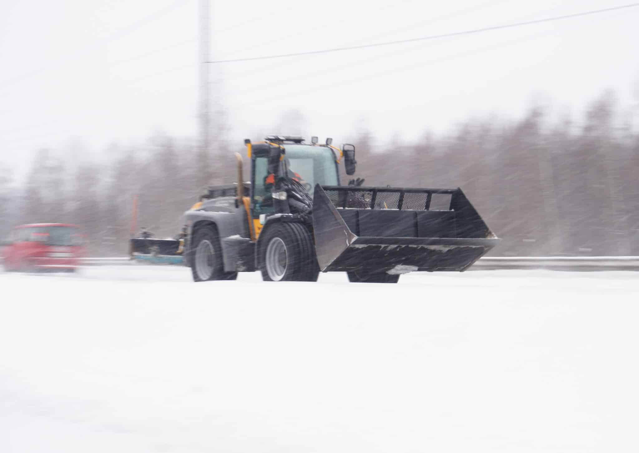 Hämeenlinna, Finland January 21st 2021 : Bulldozer moving to next site in a heavy snowstorm